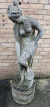 Reconstituted stone garden statue in the form of a semi-clad lady with separate circular base,