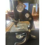 R. & J. Beck Ltd London - Model 29 japanned microscope on triform base, base repaired, serial no.