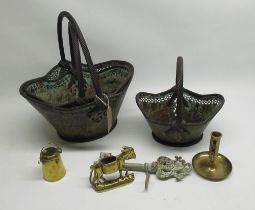 Graduated set of three pierced distressed metal lozenge shaped baskets with twist handles, brass