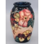 Moorcroft Pottery: Oberon pattern vase, tubelined decoration of pink and yellow flowers on a dark