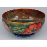 Moorcroft Pottery: Anemone pattern footed bowl, tubelined decoration of red and orange flowers on