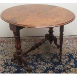 Victorian figured walnut Sutherland table, two fall leaves on fluted baluster supports and scroll