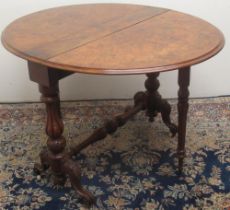 Victorian figured walnut Sutherland table, two fall leaves on fluted baluster supports and scroll