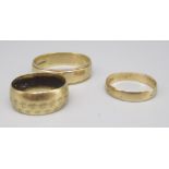 9ct yellow gold band ring, size Z1/2, and two other 9ct gold rings, all stamped 375, 9.8g