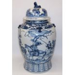 Large C20th Chinese blue and white temple jar and cover, painted with warriors and horsemen, the