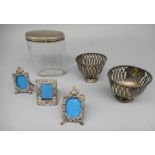 Three Sterling silver miniature easel photo. frames, two Foreign metal pierced bon-bon dishes and