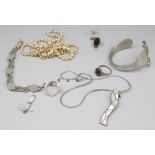 Collection of silver jewellery including a fork shaped into a bracelet, a mother of pearl necklace