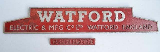 Two relief cast metal advertising signs, one for Watford Electric & MFG Co Ltd (91.6x15.4cm), the