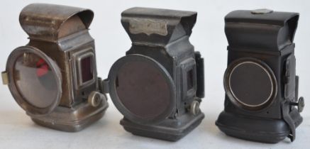 Three vintage circa 1930's oil burning bicycle lamps to include a pair of front and rear lamps by