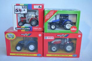 Four boxed 1/32 tractor models to include 3 x Britain's, a Steyr 6135 Profi (model mint/never