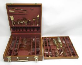 C20th Asian cased canteen of brass cutlery with stained wood handles, six place settings W43cm