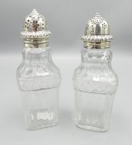 Early C19th pair of pressed glass pepperettes with silver tops H14cm