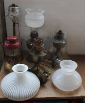 Set of six oil and Tilly lamps of various types, including chimney's and student shades.