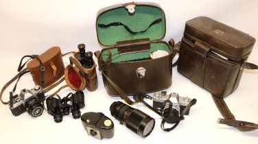 Olympus FTL and Canon AE-1 35mm SLR cameras, Kodak Brownie 127, and two pairs of cased binoculars
