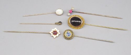 Collection on unmarked yellow metal tie pins set with various stones, including one micro mosaic,