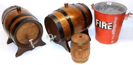 Two coopered oak barrels with taps and stands L35cm, a smaller oak barrel marked 'On loan from