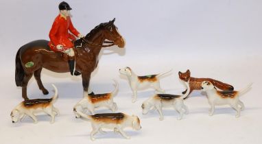 Beswick Huntsman on bay/brown horse No. 1501, fox No. 1440 with black tipped tail, and six foxhounds