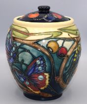 Moorcroft Pottery: Harting pattern jar and cover, decorated with flowers, butterflies, berries,