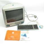 Apple iMac Personal computer featuring CD tray, with keyboard, mouse, and power supply, user