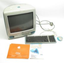 Apple iMac Personal computer featuring CD tray, with keyboard, mouse, and power supply, user