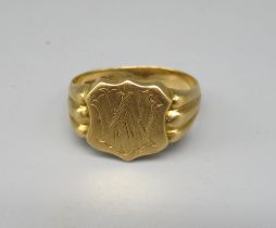 18ct yellow gold signet ring, the shield face engraved with interlocking Ws, on grooved shoulders,