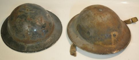 Vintage British steel Brodie helmets, one marked "R" (Rescue Party) front and back (2)