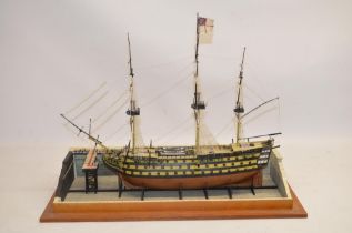 Built up plastic kit (likely 1/180 scale Airfix) of HMS Victory in dry dock with diorama setting