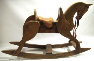 Wooden rocking horse with tan leather seat