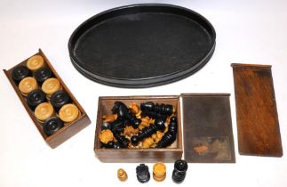 Set of early C20th chess pieces and a set of draughts, both complete and boxed, and an oval dressing