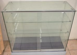 Large glass shop display cabinet with 3 removeable shelves and sliding front doors. W101.7xD45.