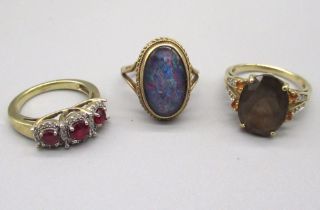 9ct yellow gold ring set with faux opal, and two other 9ct gold rings set with coloured stones,