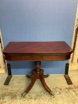 George 1V mahogany tea table, swivel folding top on turned support and four sabre legs with brass