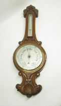 Early C20th carved oak aneroid wheel barometer with thermometer box H82cm