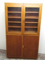 C20th light oak bookcase with two glazed and two panel doors, W108cm D30cm H188cm