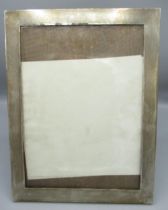 George V silver engine turned easel photograph frame, oak back, hallmarked Birmingham 1919, 25.6cm x