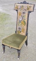 Victorian ebonised nursing chair with needle and beadwork back panel, velvet seat on turned tapering