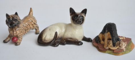 Three Beswick animal figurines, Cairn Terrier with ball, a resting Siamese cat and Beswick Studio