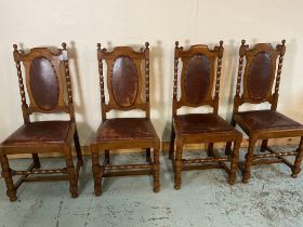 Set of four oak dining chairs with leather upholstered backs and seats on bobbin turned supports