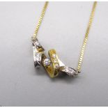 18ct yellow and white gold twisted pendant set with nine brilliant cut diamonds, on 18ct yellow gold