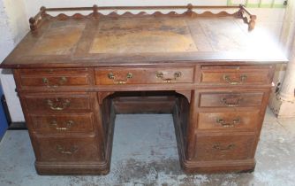 Victorian panelled oak pedestal desk with galleried top, three frieze and six pedestal drawers