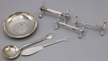 White metal dish with inset silver Austrian coin dated 1780; pair of EPNS knife rests; mother of