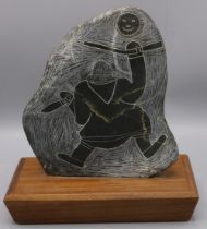 C20th Inuit art carved soapstone plaque on wooden plinth, H22.5cm