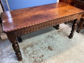 C17th style oak rectangular dining table, scroll carved frieze on turned and block supports,