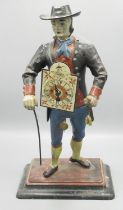 C20th painted spelter table clock in the form of a Dutch peddler with arched dial fronting on shaped