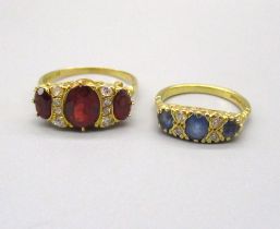 18ct yellow gold and red stone ring, size R, and an 18ct yellow gold diamond and sapphire ring, size