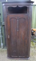 C20th oak arts and crafts style hall corner wardrobe with carved floral motifs, open shelf above