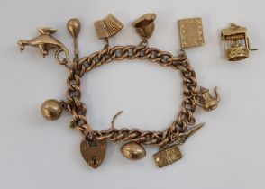 9ct gold charm bracelet of eleven individually hallmarked charms on rose gold link bracelet with