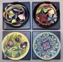 Moorcroft Pottery: four trial pin dishes/coasters - vines and flowers on dark blue ground, dated '