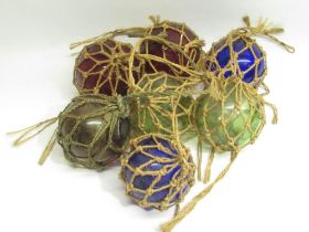 Seven C20th coloured glass fishing floats