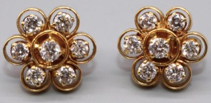 Pair of yellow metal floral cluster earrings, each set with seven brilliant cut diamonds in claw